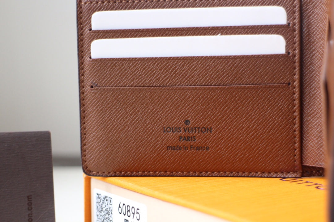 Louis Vuitton brown cardholder, embossed logo and inner card slots