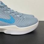 Light blue and gray textured basketball shoe upper with blue swoosh and white midsole.