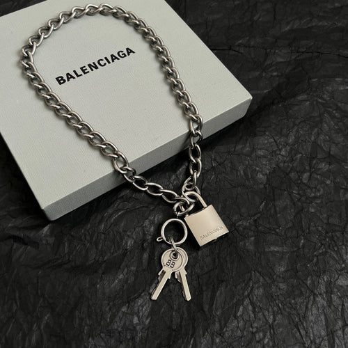 Silver-tone chain bracelet with padlock charm and keys, shown with a box