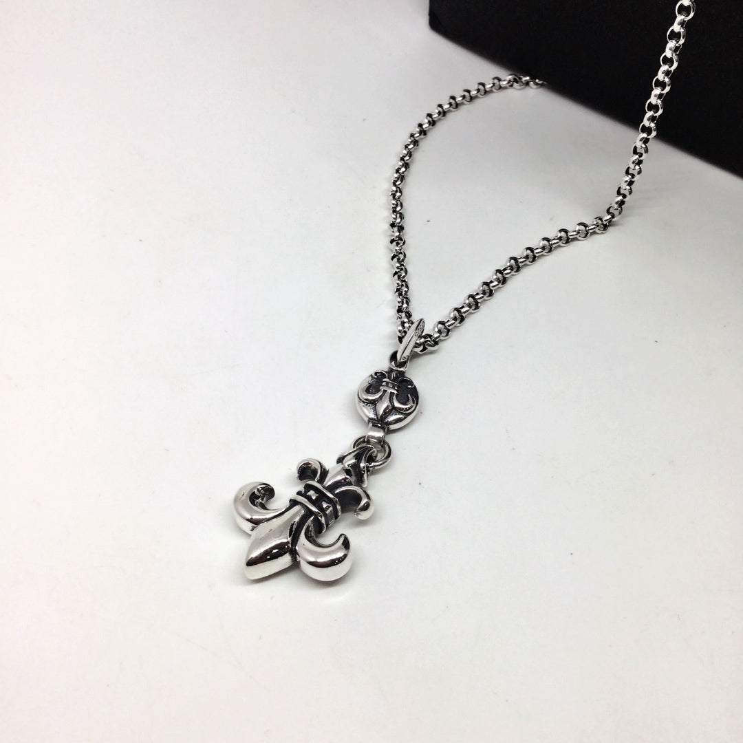 Silver chain necklace with anchor-shaped and floral charms