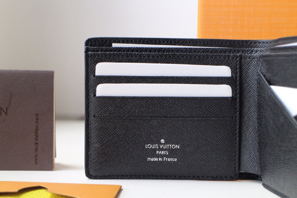 Black Louis Vuitton small bag wallet interior with card slots and brand stamp