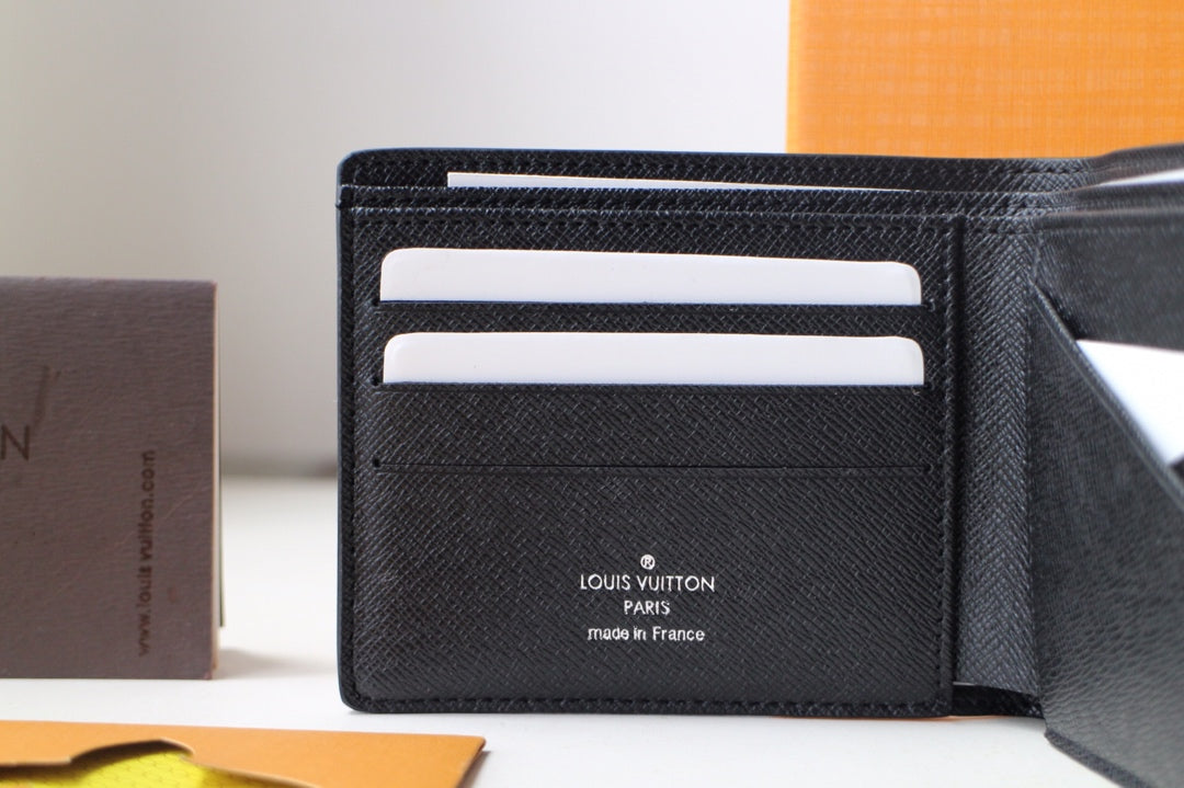 Black Louis Vuitton small bag wallet interior with card slots and brand stamp