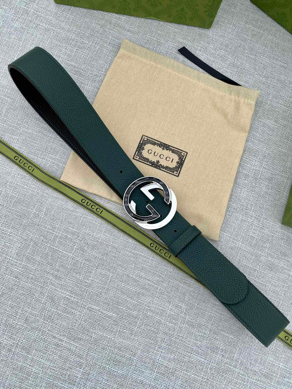 Gucci belt dark green leather with round GG logo buckle and short end