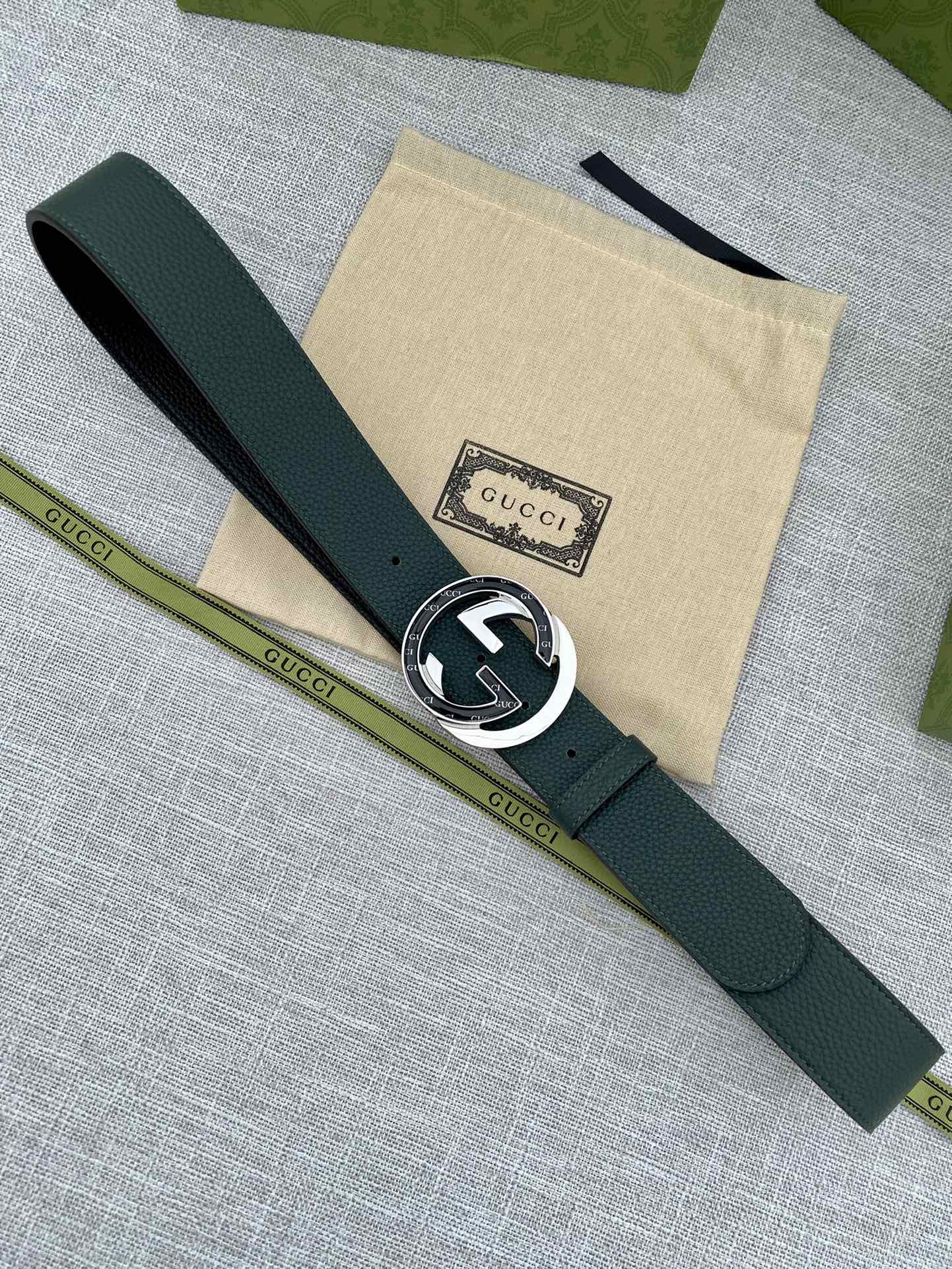 Gucci belt dark green leather with round GG logo buckle and short end