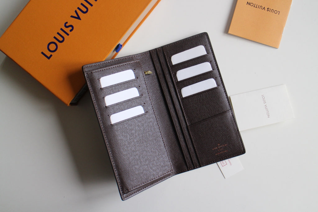 Louis Vuitton small wallet open, gray lining with multiple card slots and interior logo