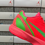 Red low-top sneaker with green side panel and sculpted foam sole, lace-up