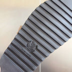 Sandal outsole with textured rubber tread, dark gray.