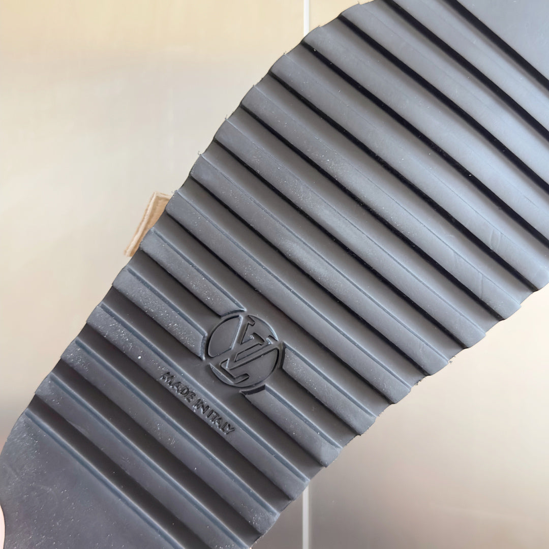 Sandal outsole with textured rubber tread, dark gray.