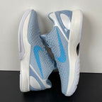 Light blue and gray basketball shoes with white sole, blue swoosh panel, lace-up.