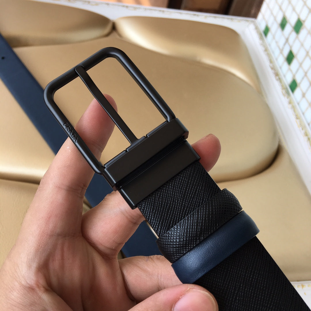 Navy belt close-up with arched buckle and textured strap, hand holding.