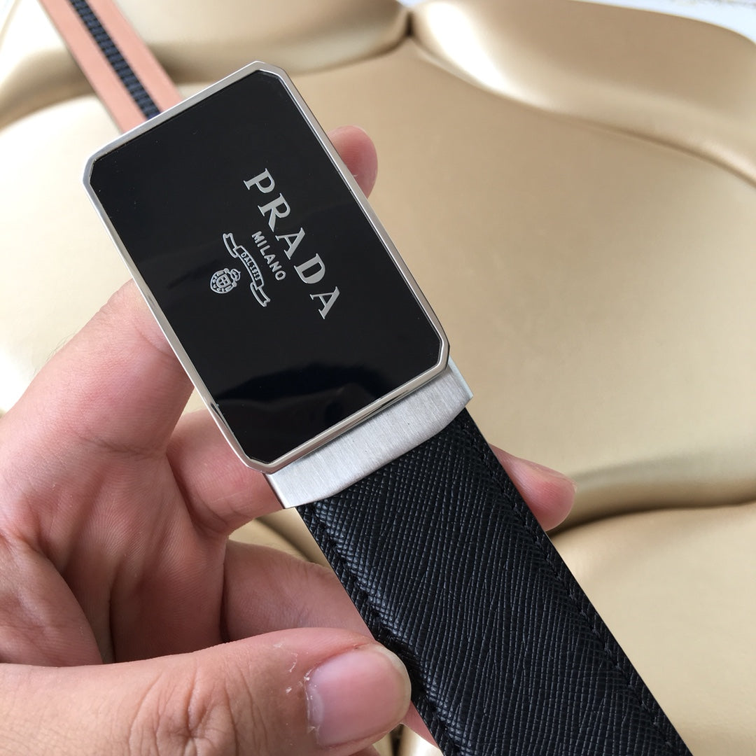 Leather belt with dark strap and silver-edged black Prada buckle, held in hand