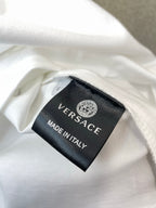 Inside neck label: VERSACE, MADE IN ITALY on white T-shirt.
