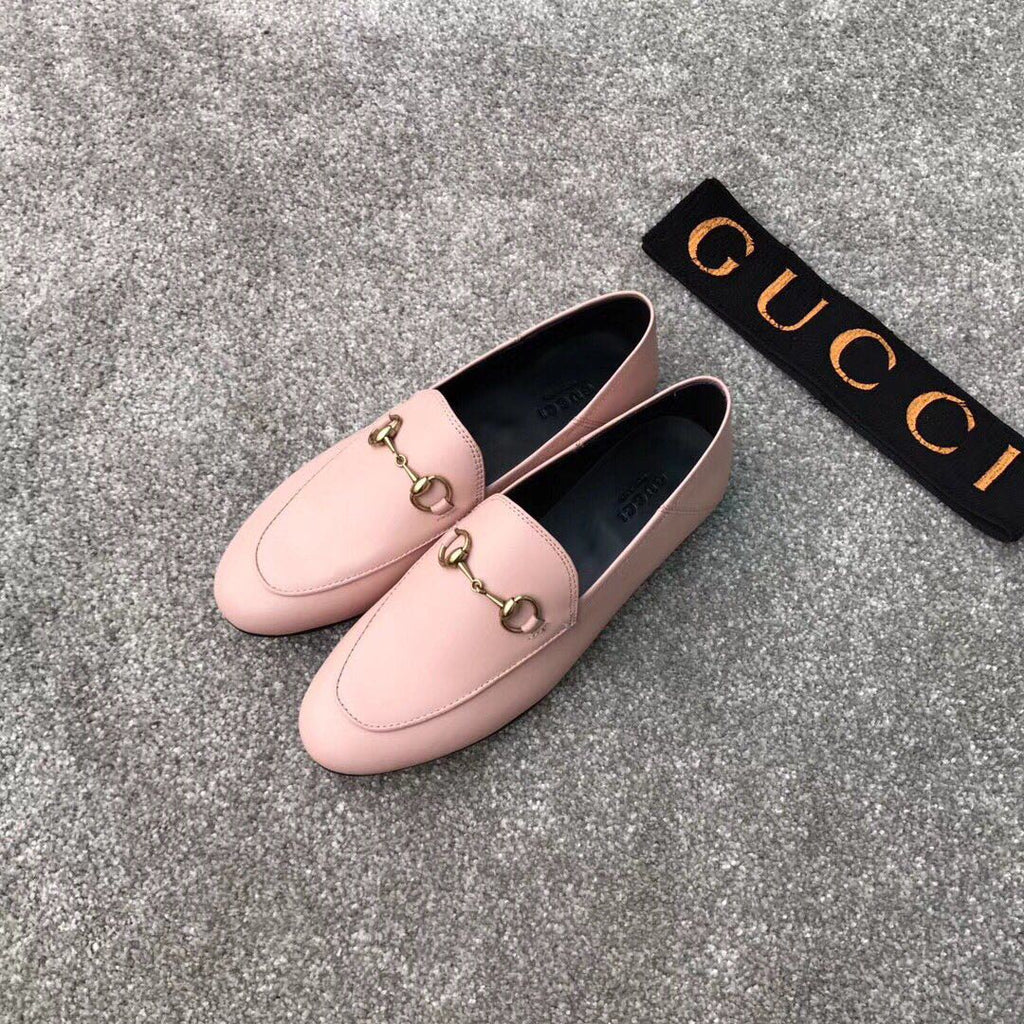 Pink Gucci loafers, rounded toe with gold-tone bit detail and smooth vamp, pair view