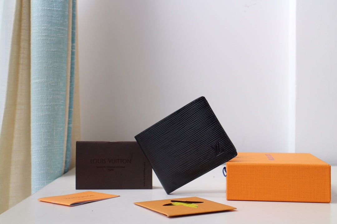 Black Louis Vuitton small bag wallet with textured exterior, angled view