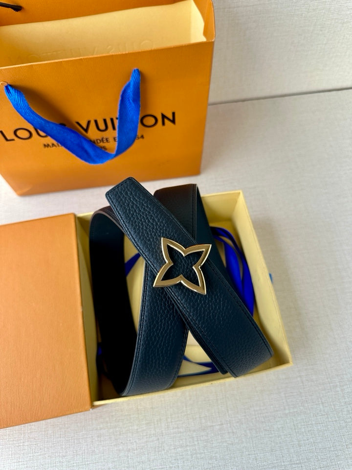 Navy leather belt with star buckle, partially unboxed from gift box