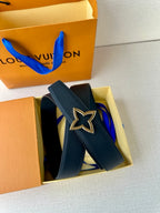 Navy leather belt with star buckle, partially unboxed from gift box
