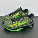 Pair of black and green basketball shoes with neon laces, textured upper, and bright green sole.