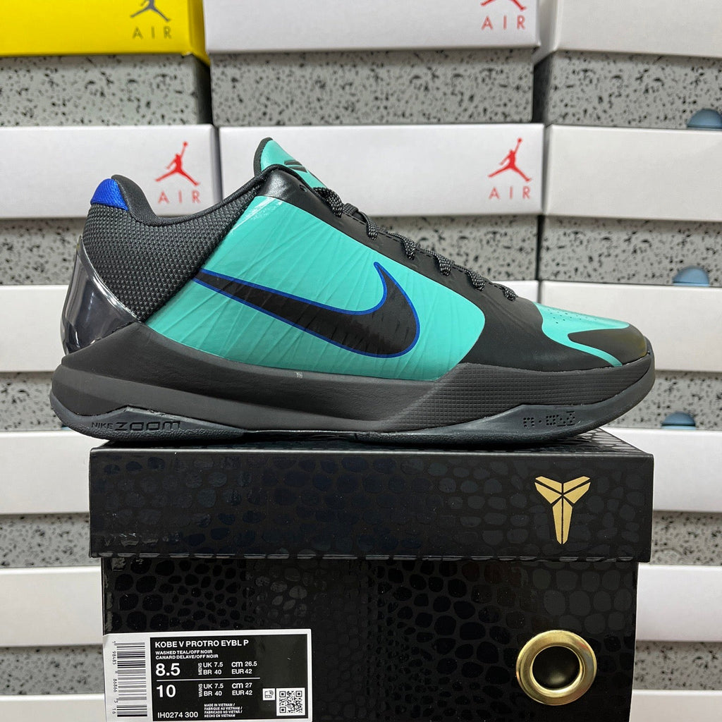 Black and teal basketball shoe shown in side view with blue swoosh detail.