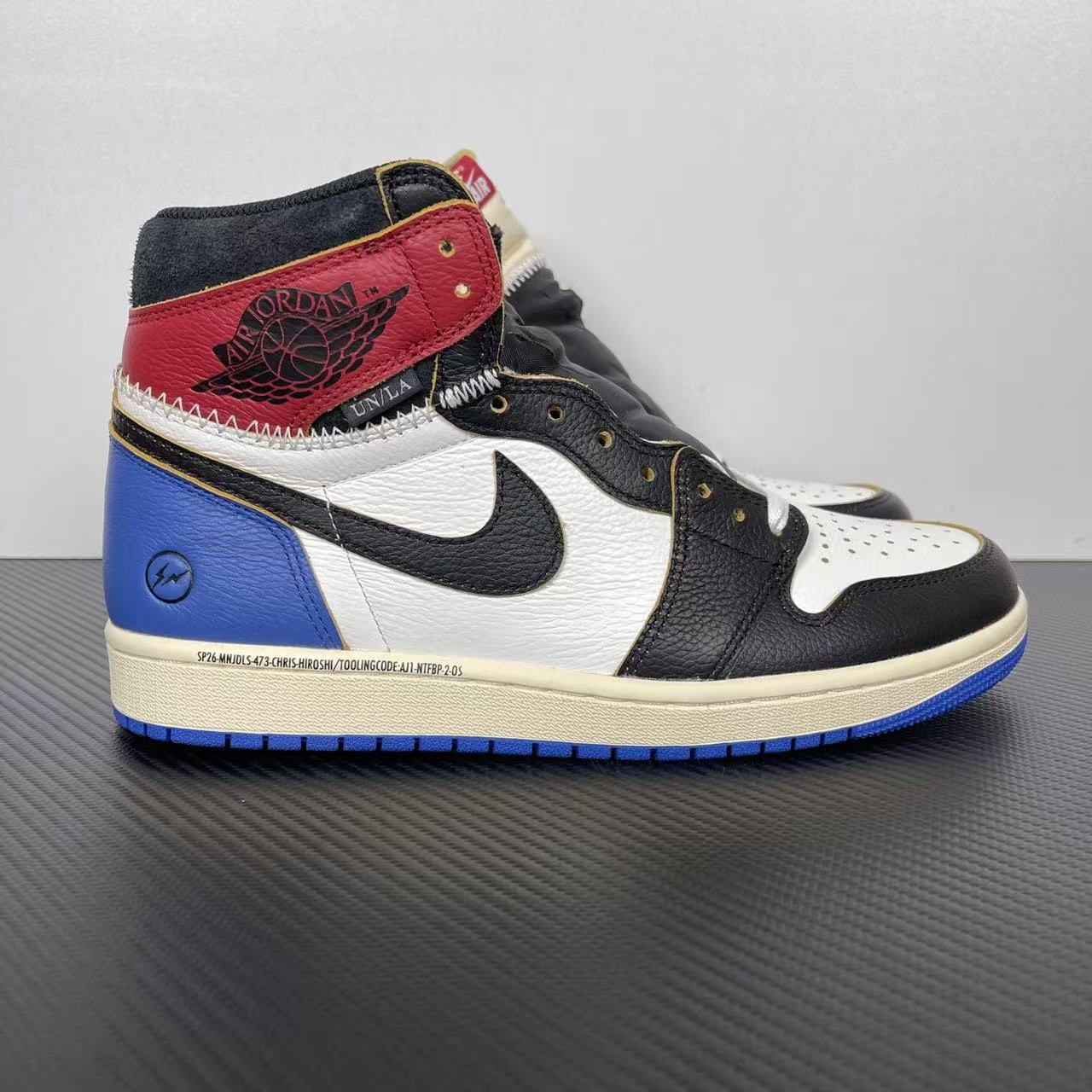 High-top sneakers with black, white, red, and blue panels; Nike swoosh on side