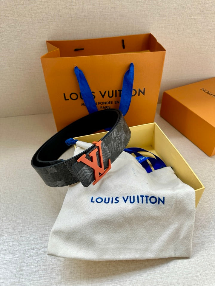 Louis Vuitton belt with orange LV buckle and dark checkered strap, resting flat