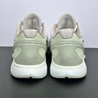 Pair of low-top sneakers back view, pale green heel and collar, white outsole