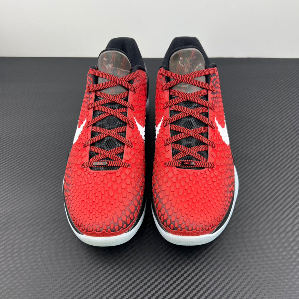 Pair of red basketball shoes with black laces and white swoosh on the sides.