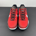 Pair of red basketball shoes with black laces and white swoosh on the sides.
