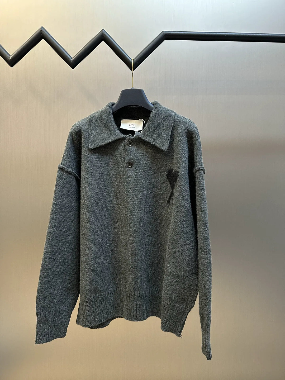 Grey long-sleeve knit polo sweater with button placket and pointed collar