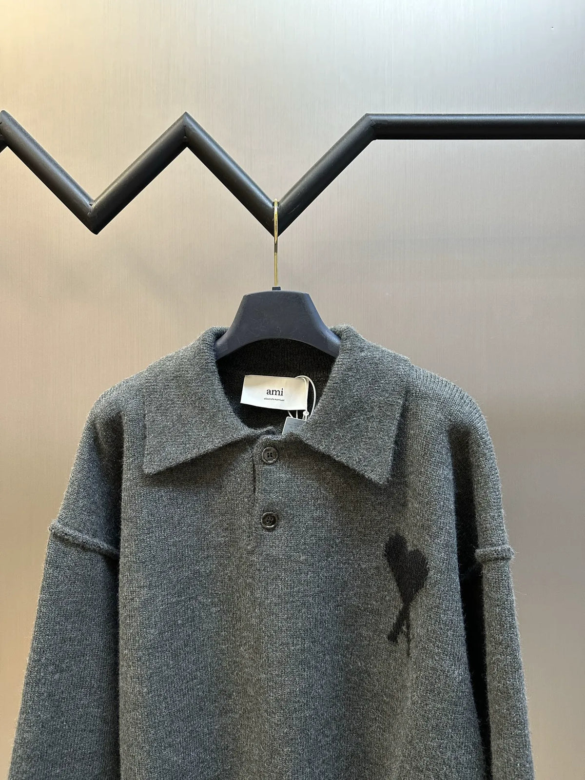 Grey long-sleeve knit polo sweater with buttoned pointed collar