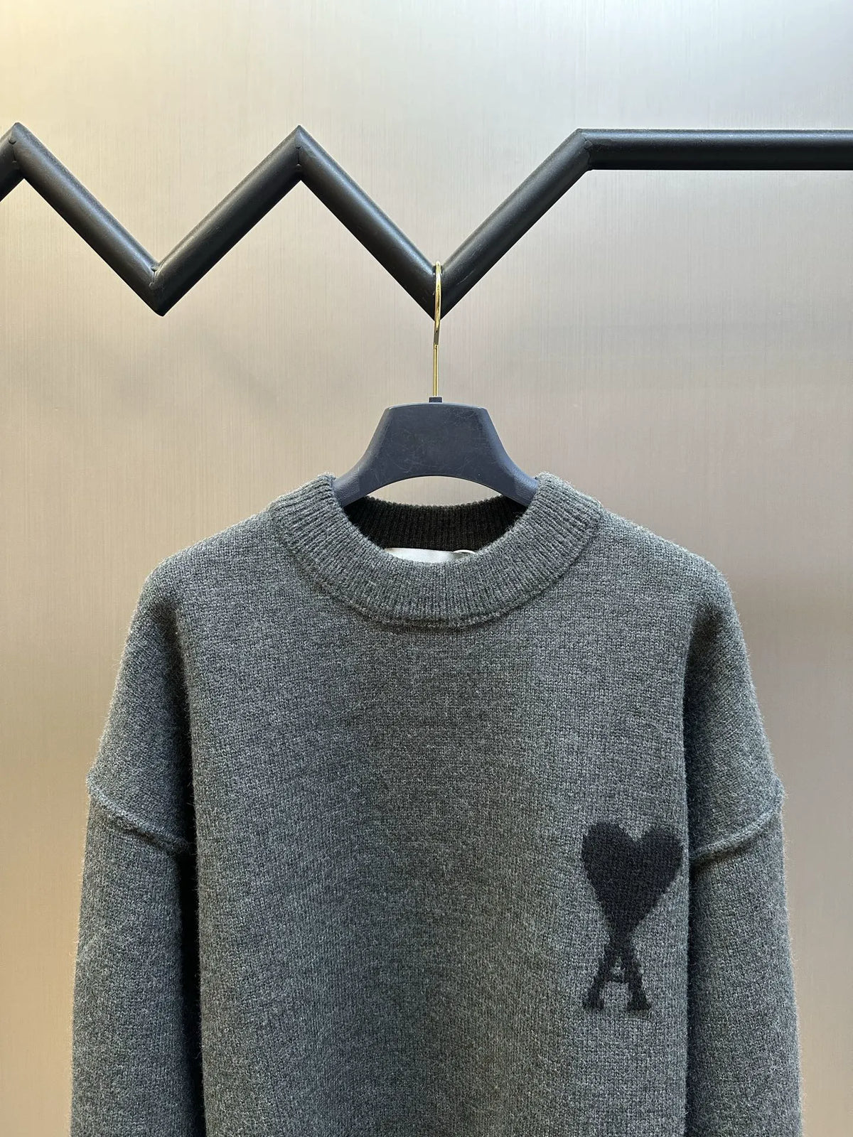 Long-sleeve knit sweater front view, heather gray with heart-and-A logo