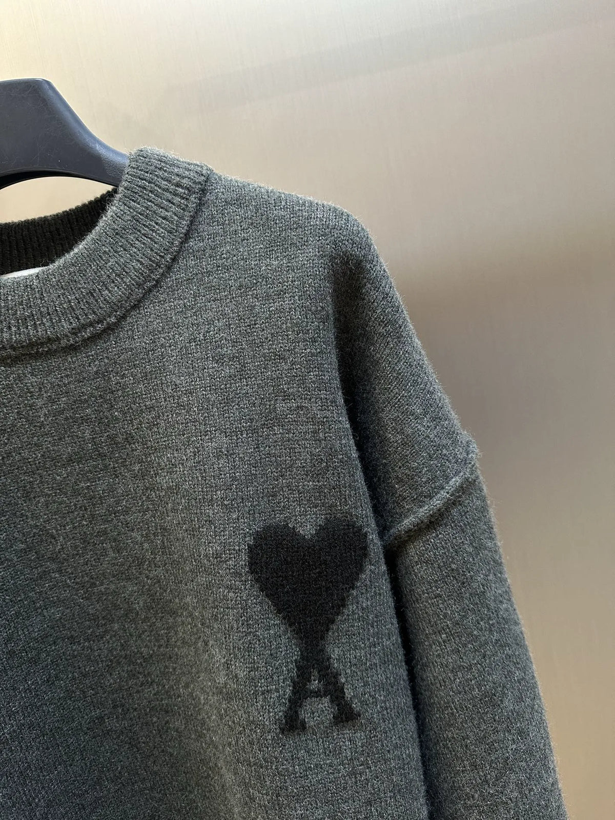 Heather gray sweater with black heart-and-A graphic on front