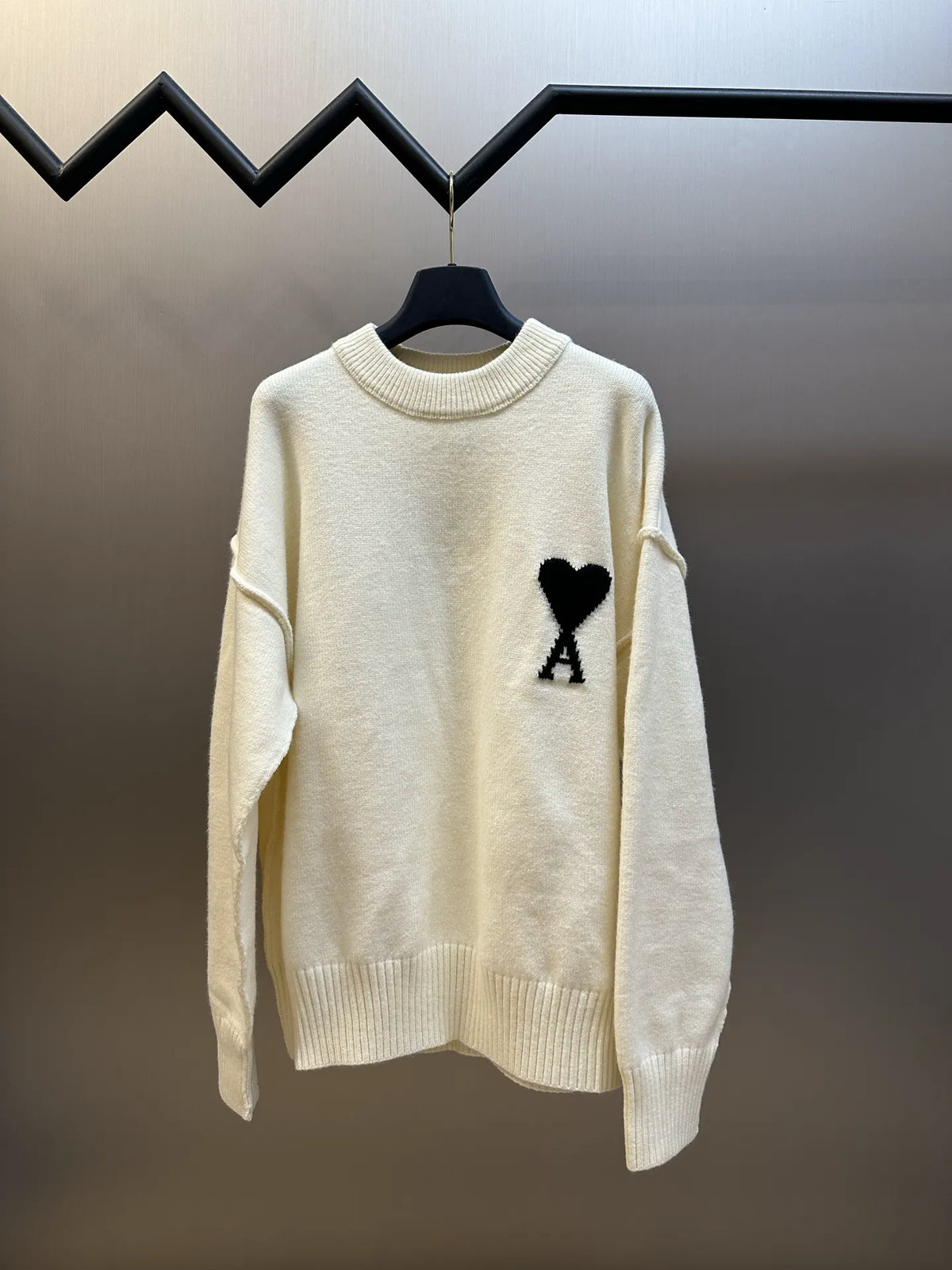 Amiri long-sleeve knit sweater, cream with black heart and A patch on front