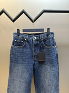 Dark blue denim jeans, back view with patch pockets and button waistband.
