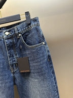 Dark blue denim jeans with curved pocket stitching and visible Louis Vuitton label.
