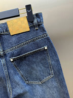 Dark blue denim jeans with front pocket and stitched edge trim.