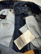 Dark blue denim jeans with inner lining and care labels at the waistband.