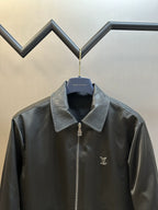 Dark monogram zip-up jacket with stand collar, center zipper, chest logo