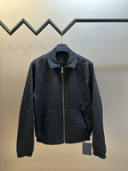 Dark monogram zip-up jacket with stand collar, chest logo, and zip front