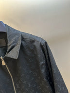 Dark monogram zip-up jacket shoulder detail with snap flap pocket