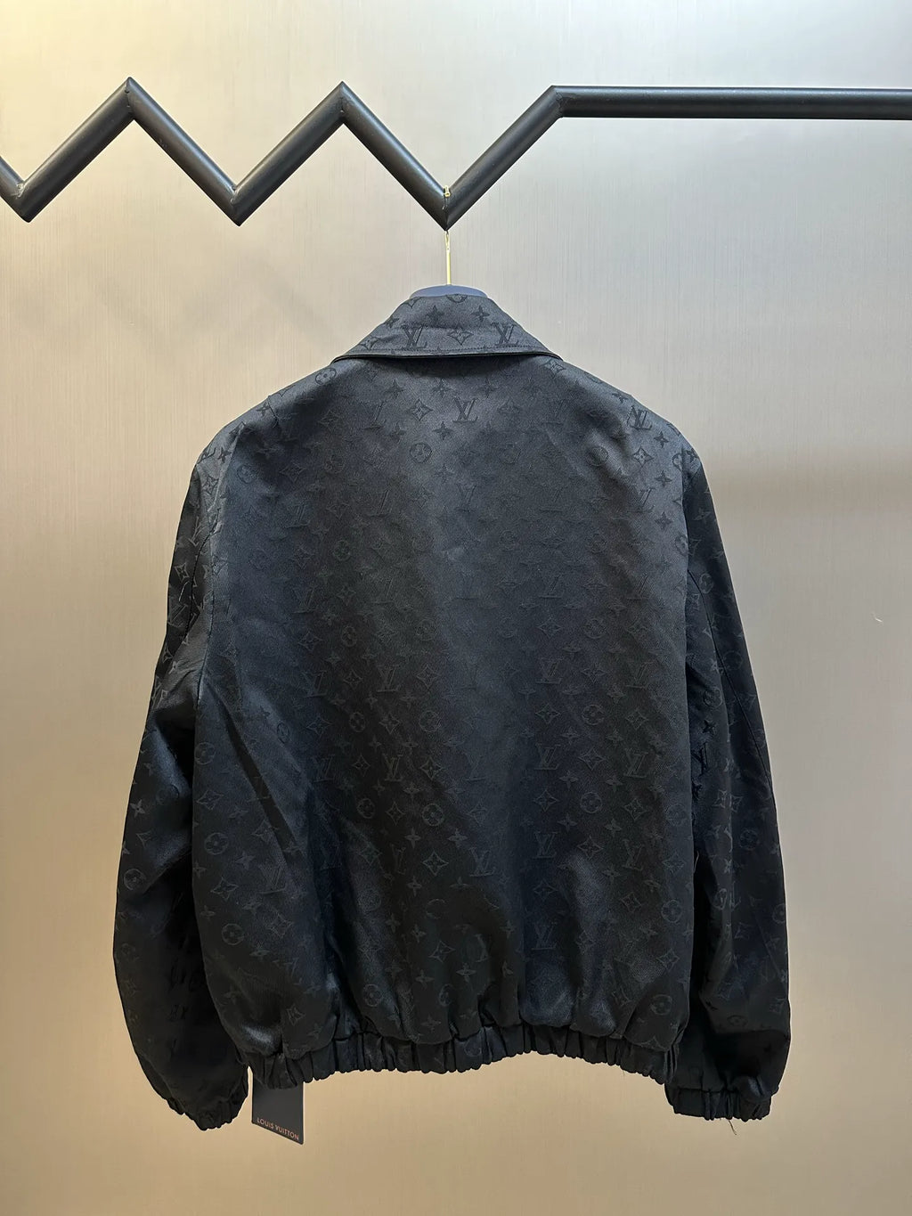 Dark monogram zip-up jacket back with ribbed hem and gathered shoulders