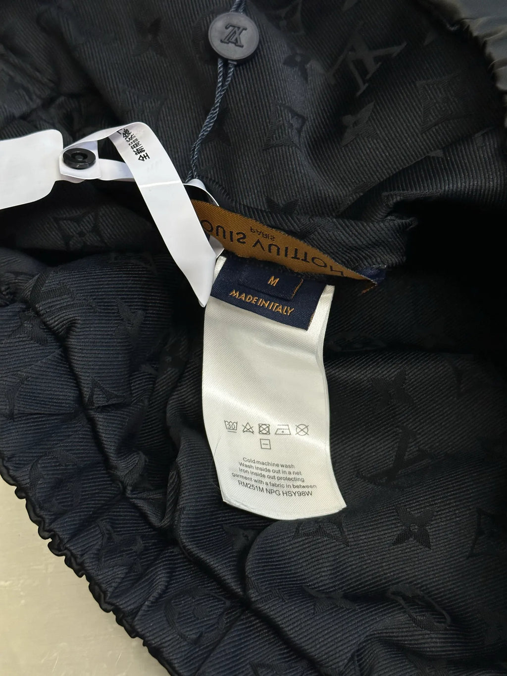 Dark quilted jacket lining with size label and care information tag