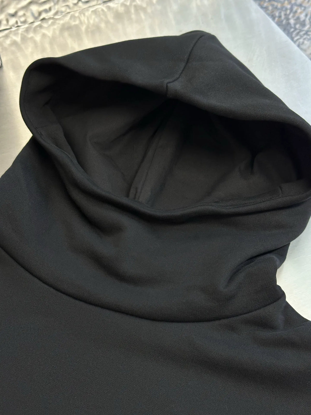 Black hoodie hood close-up with lined interior