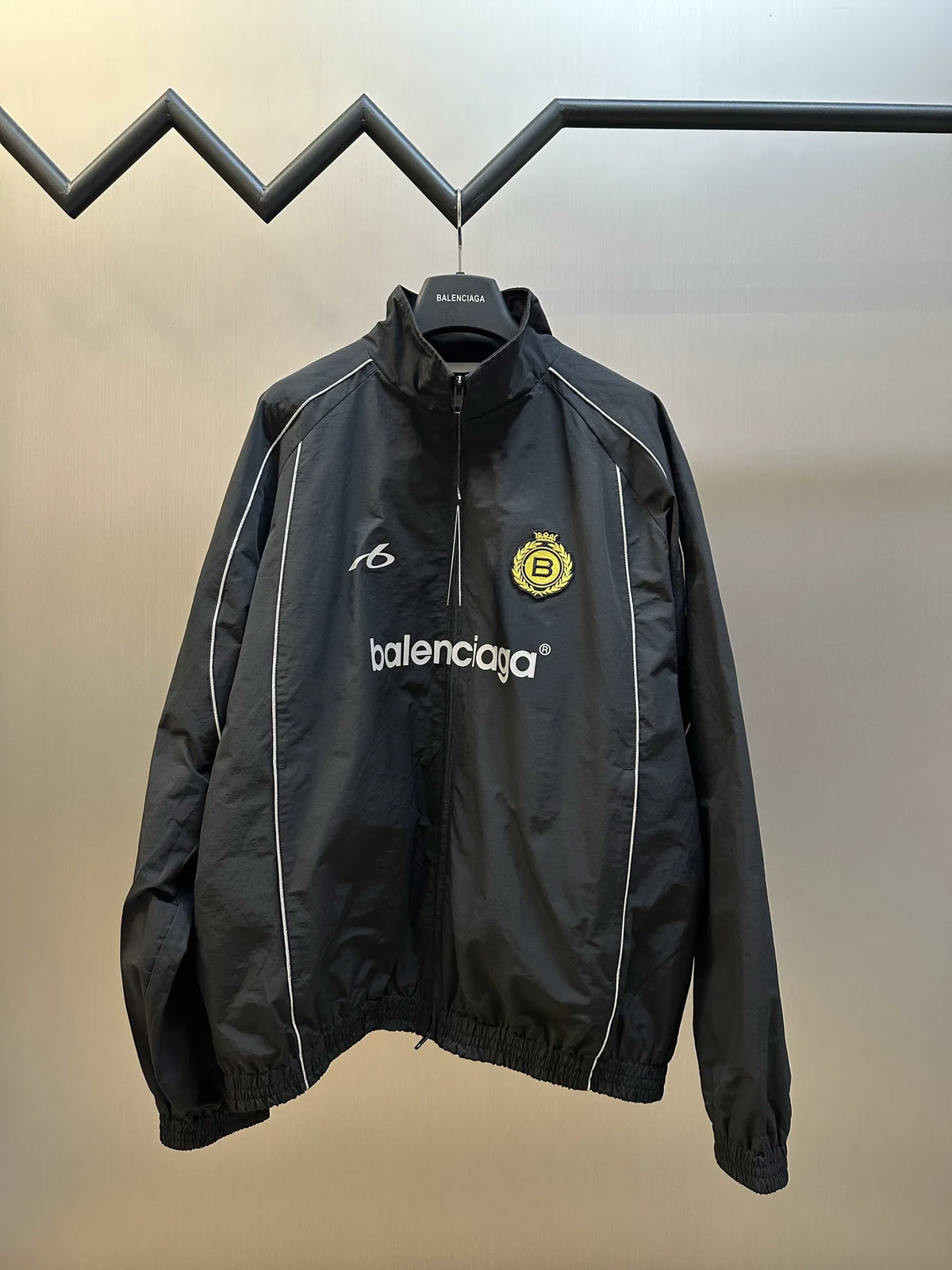 Balenciaga black windbreaker coat with front zipper and embroidered logo patches
