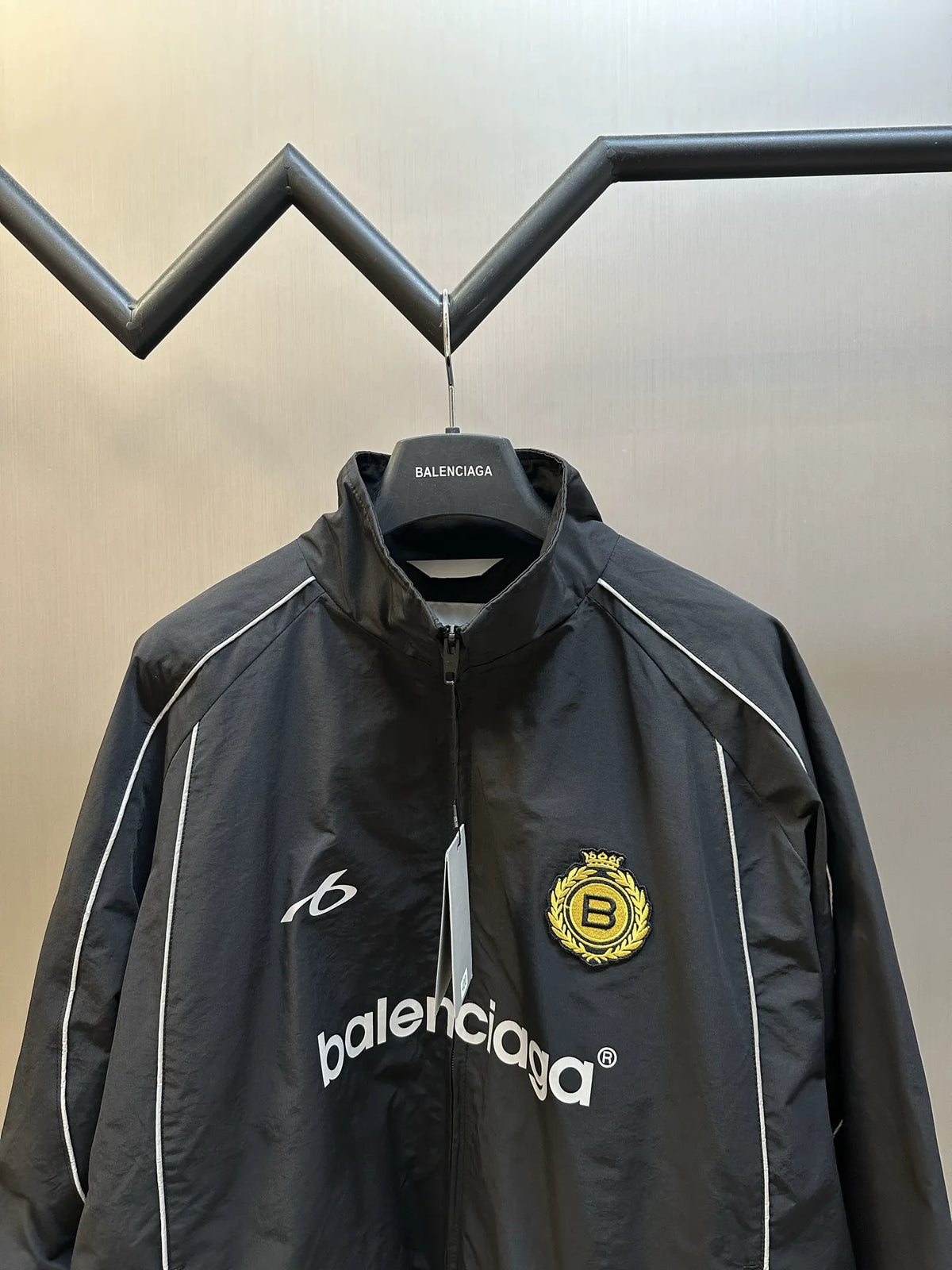 Balenciaga black windbreaker coat with stand collar, zipper, and chest logos