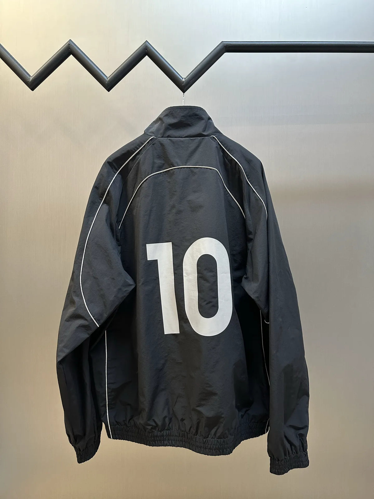 Balenciaga black windbreaker coat back view with large white number print
