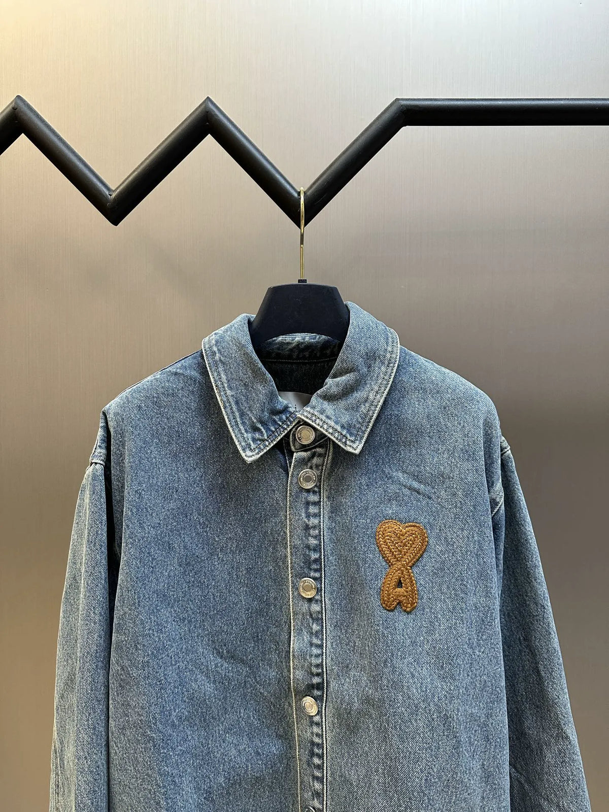 Amiri blue denim jacket with button placket and gold embroidered ribbon logo