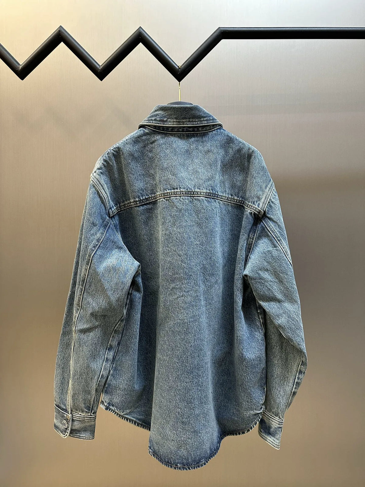 Amiri blue denim jacket back with yoke seam and worn wash finish