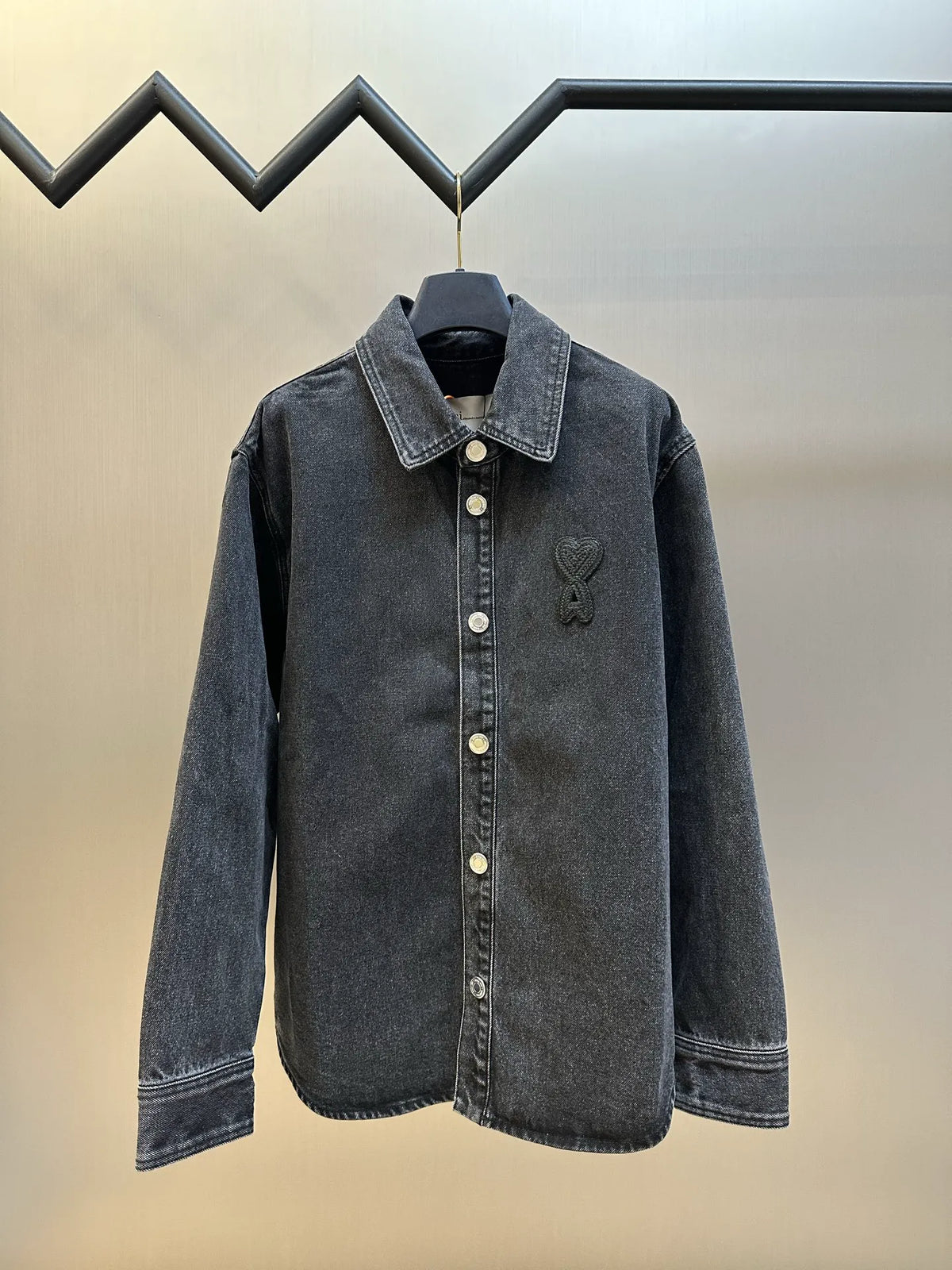 Dark blue denim jacket with button front and pointed collar