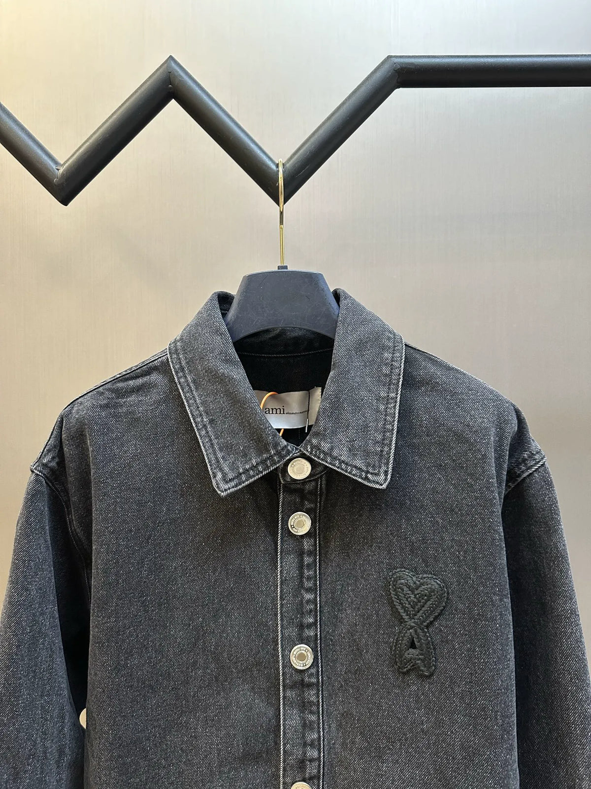 Dark blue denim jacket with chest logo embroidery and snap buttons