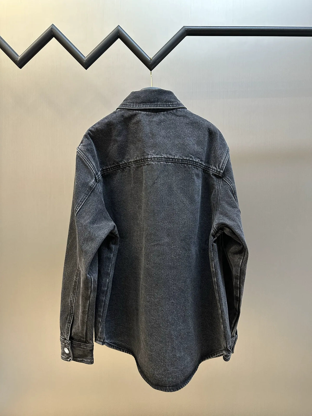 Dark blue denim jacket, back view, button placket and yoke